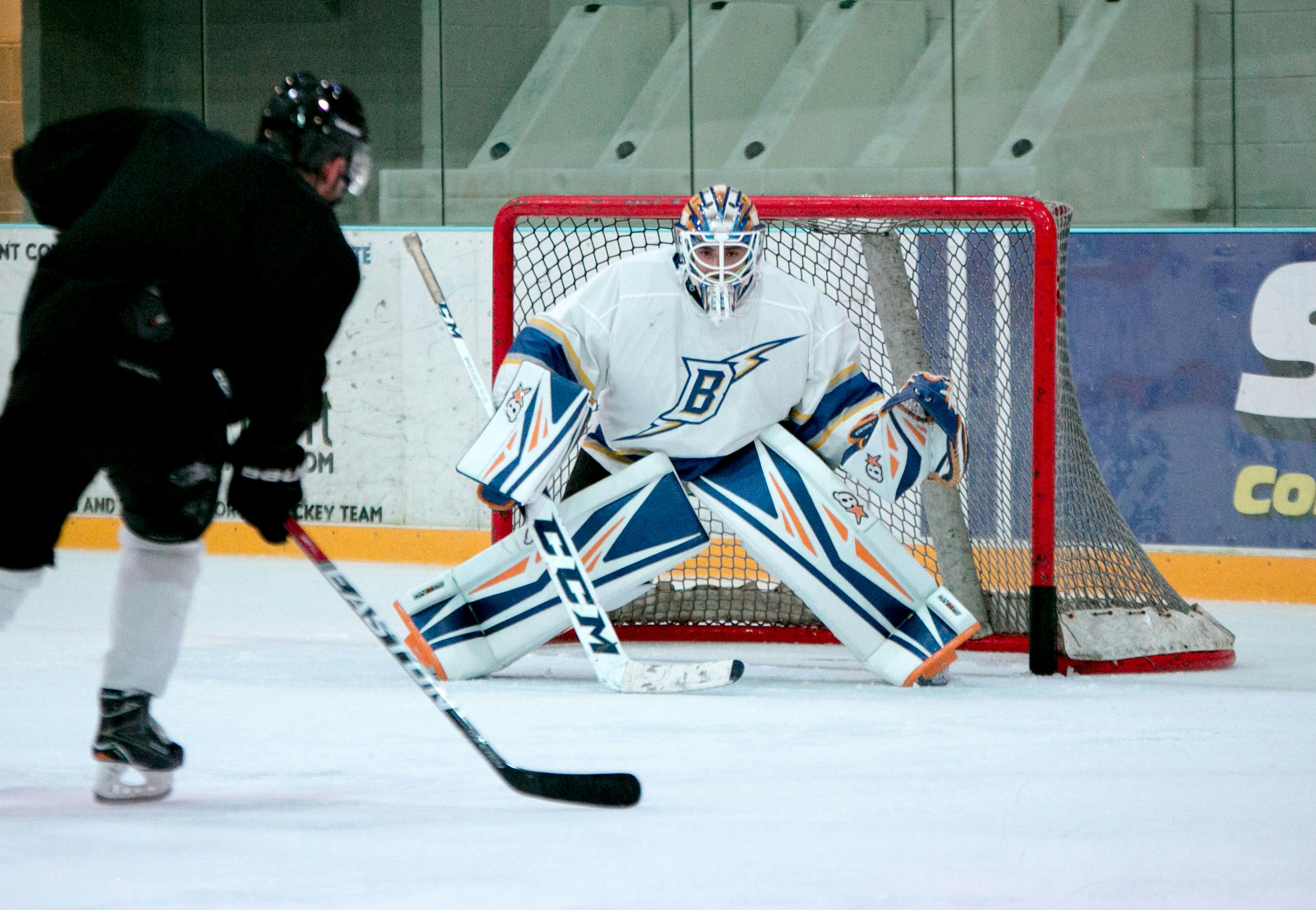 Hockey Game with Goalie blocking a shot